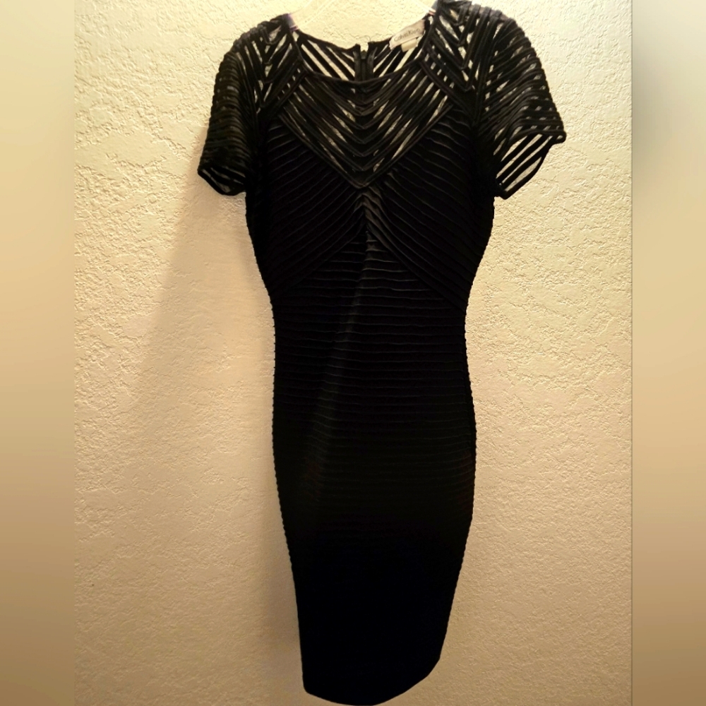 Like new- Calvin Klein fitted black sheer overlay dress.